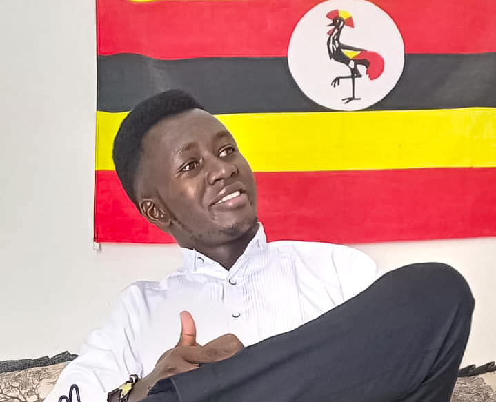 Sunday Emmanuel picture Infront of Ugandan Flag